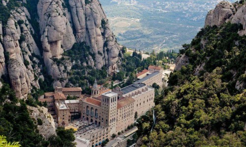 Rocky city in the mountains of Montserrat, panorama, top view of the city, bright greenery and beautiful views.